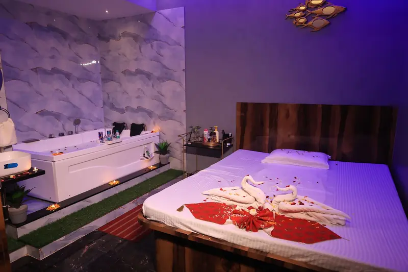 Candle-lit aroma therapy suite with jacuzzi at Kyraa Luxury Spa