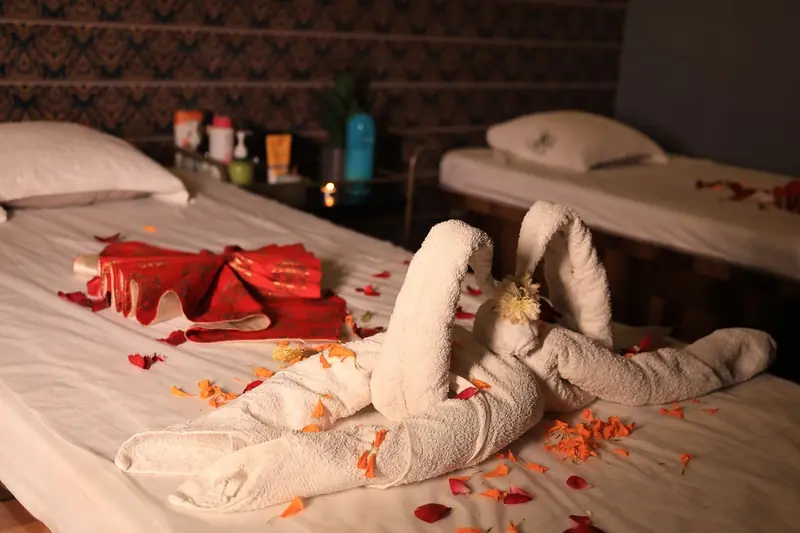 Couple massage room with rose petals at Kyraa Spa Surat
